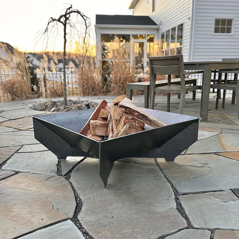 Steel fire pit on backyard patio.