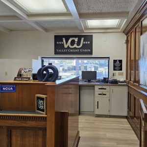 Custom metal sign layered and stencil cut for Valley Credit Union drive-up window wall.