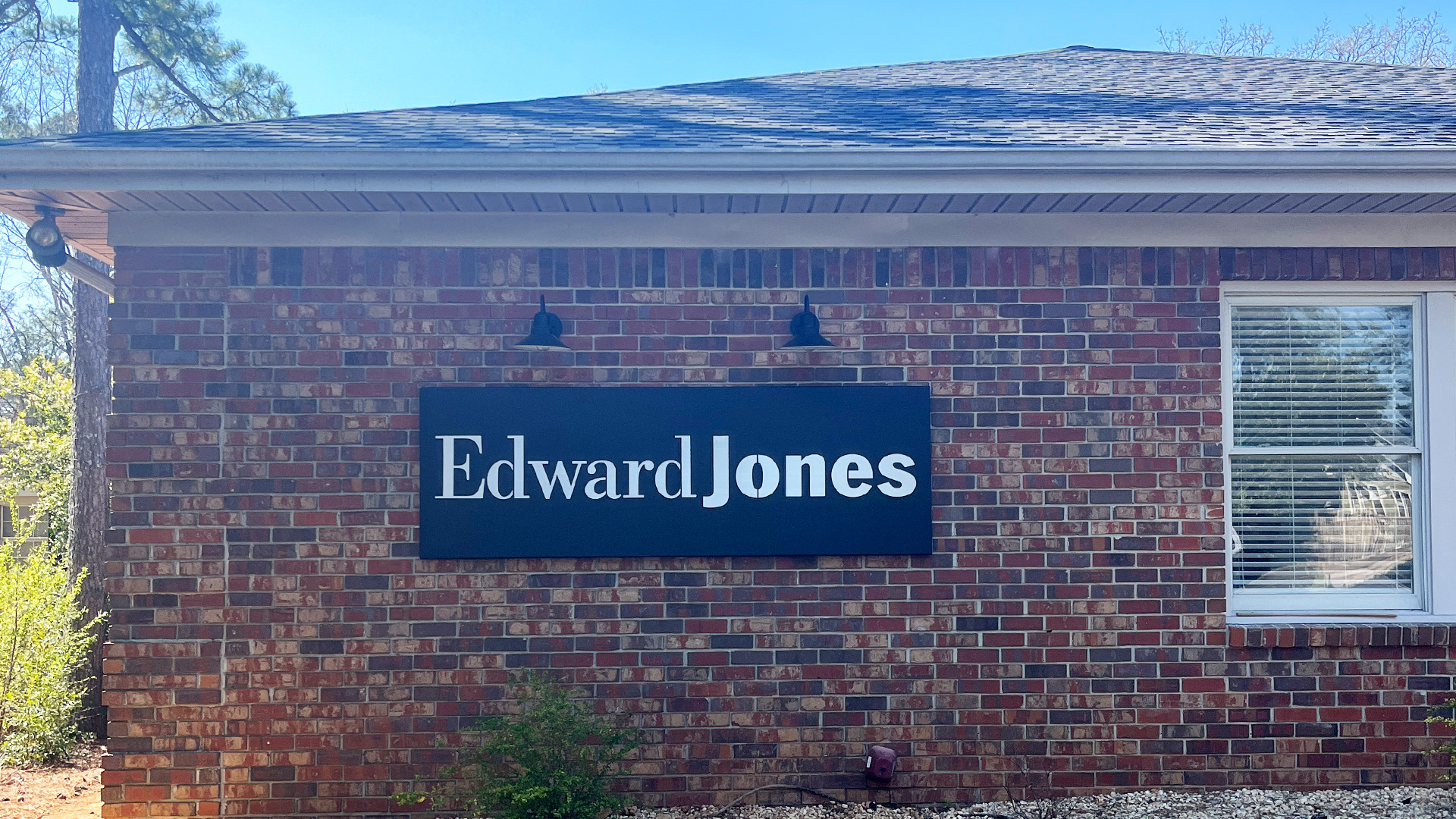 Custom metal box sign powder coated black with alluminum backplate on building exterior by Alabama Metal Art.