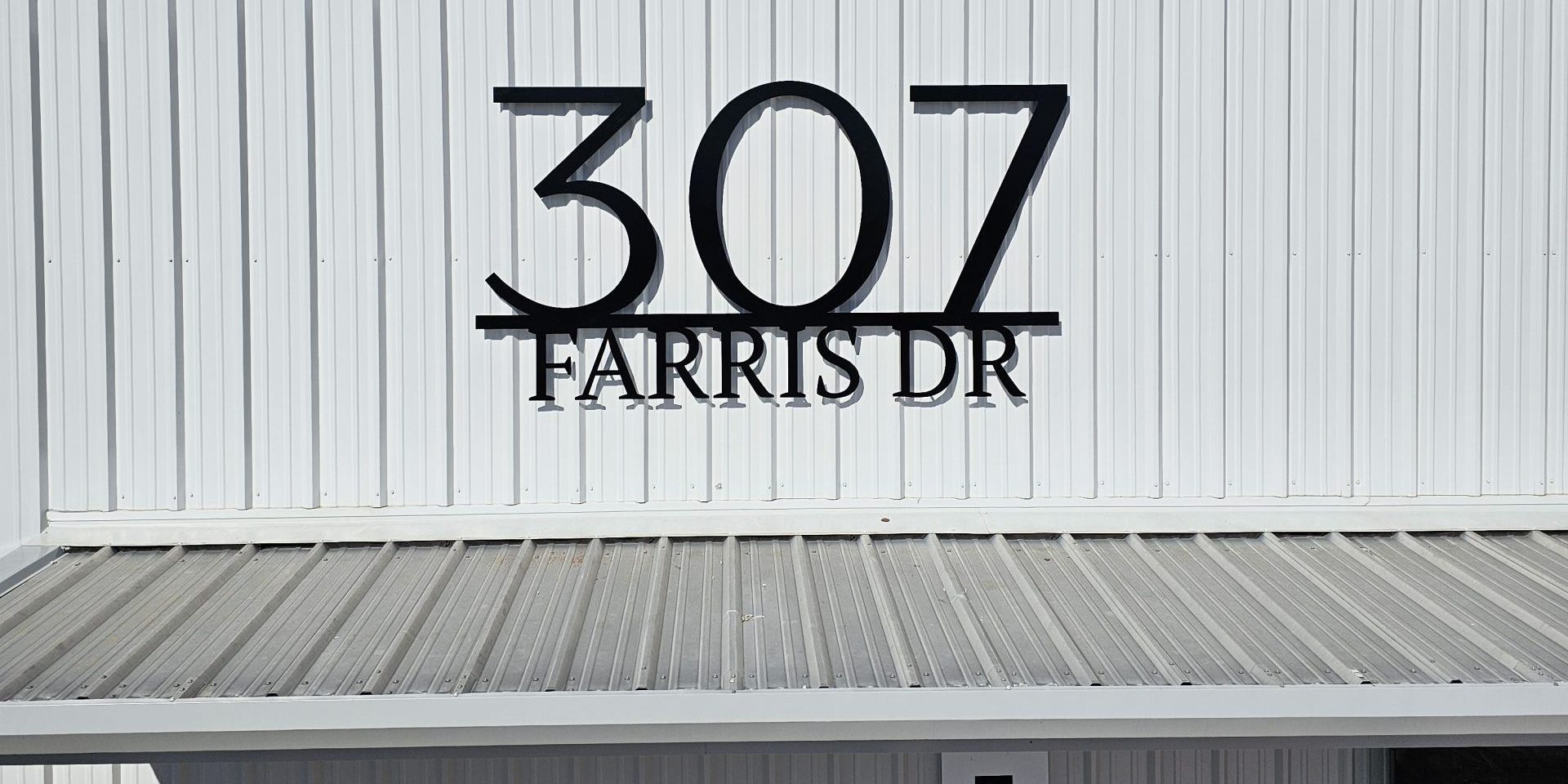 Custom metal address sign for Farris Wholesale in Tuscumbia, AL by Alabama Metal Art.