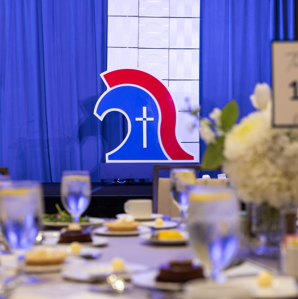 Mobile logo sign on stage at Trinity Christian Academy by Alabama Metal Art.