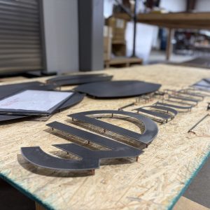 Custom metal logo in production by Alabama Metal Art.